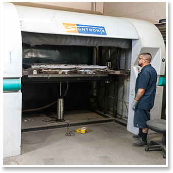 Signtronix Employee Helping Make Sign In Factory 