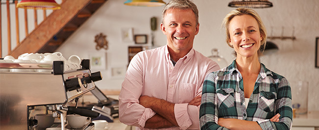 5-12 Older Couple Happy with their Business Signs