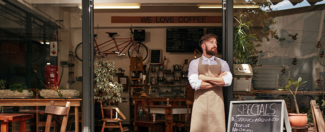 5-6 Man Standing In Front of His Business Proud of His Business Signs