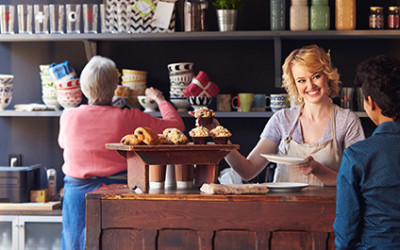 Business Owner Smiling With Customer Who Noticed Her Business Sign