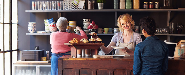 Business Owner Smiling With Customer Who Noticed Her Business Sign