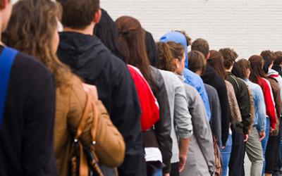 People Waiting In Line To Enter Store With Great Business Sign - 3-5