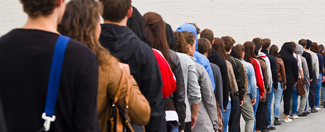 People Waiting In Line To Enter Store With Great Business Sign - 3-5