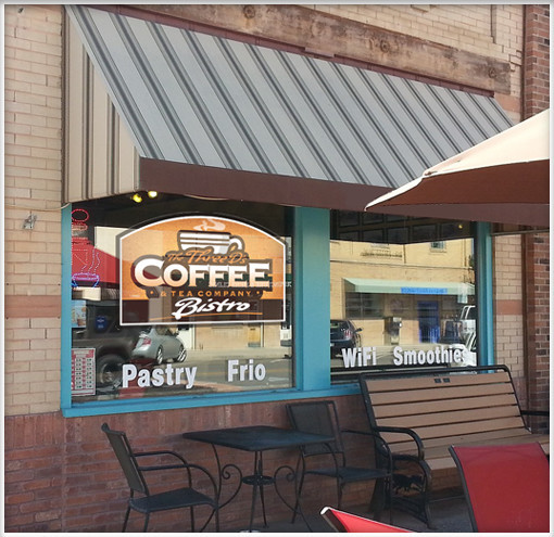 indoor led sign hanging in window of coffee shop in erie